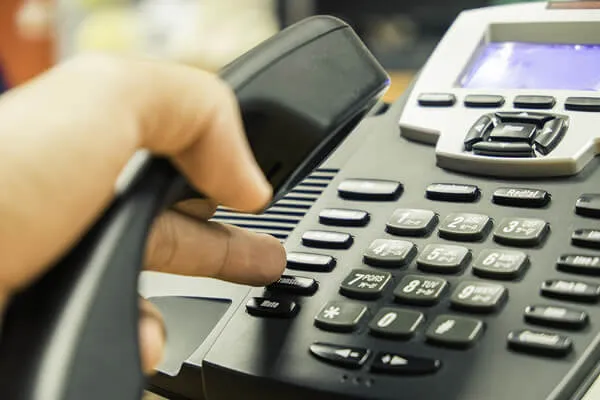 Hand operating a telephone