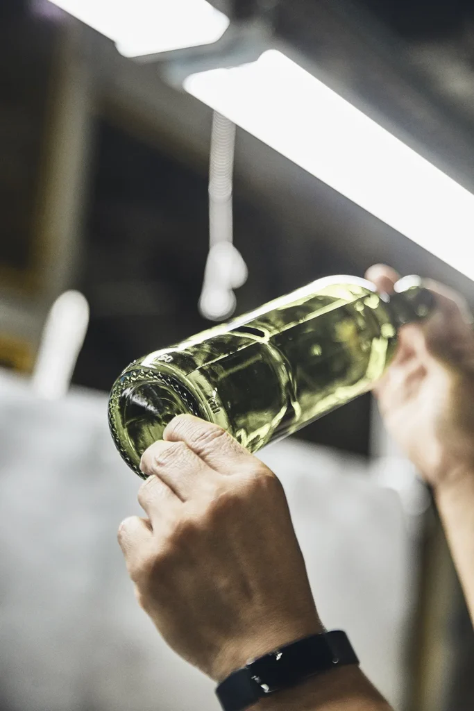 Hand holding a glass bottle