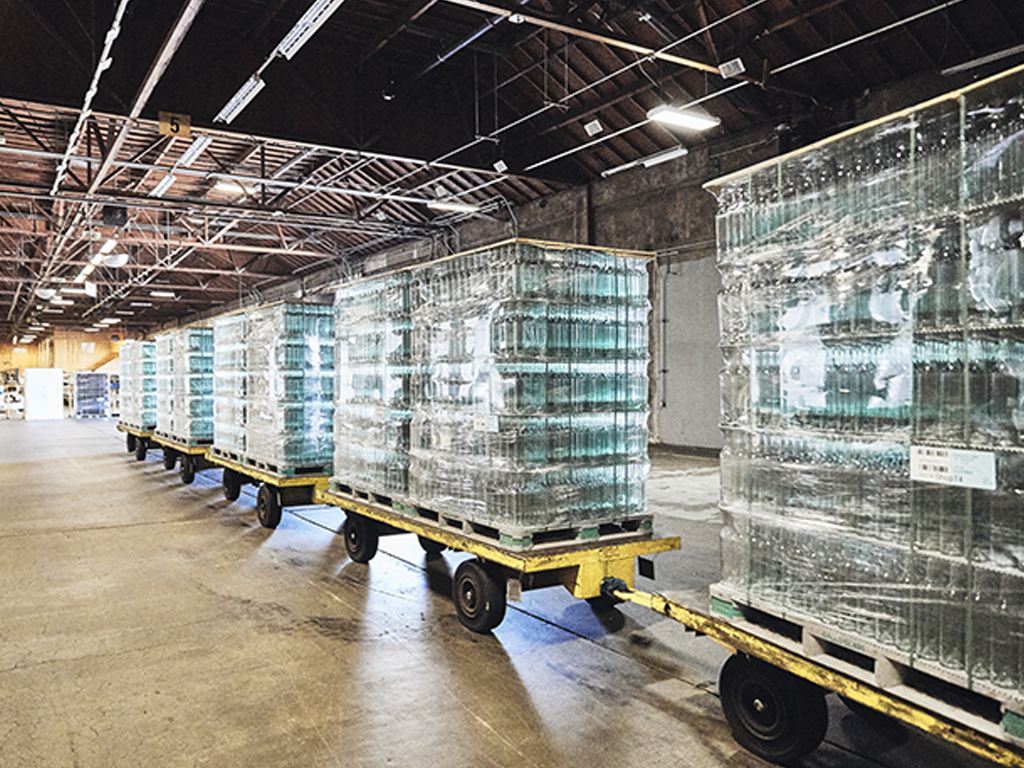 Palletize glass bottle being transported